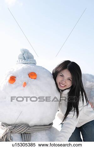 Young woman with snowman View Large Photo Image Stock Photography - Young woman with snowman. Fotosearch