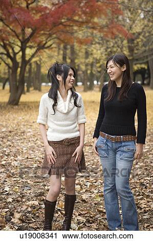 Stock Image - Two young women walking. Fotosearch