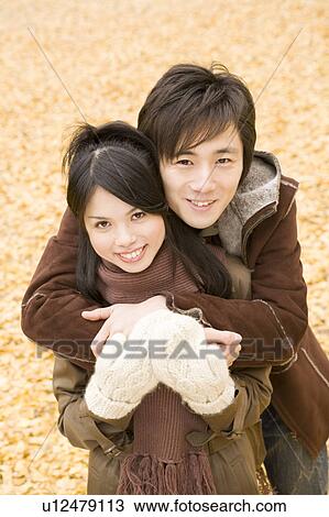 Stock Image - Young couple looking at camera. Fotosearch
