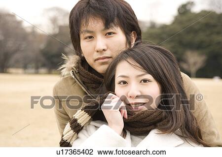 Stock Image - Young couple looking at camera. Fotosearch