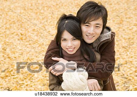 Young couple looking at camera View Large Photo Image Stock Image - Young couple looking at camera. Fotosearch