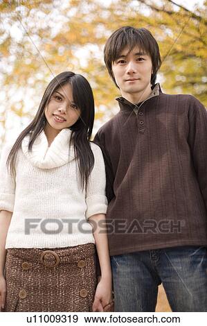 Stock Photo - Young couple looking at camera. Fotosearch