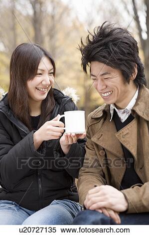 Stock Photography - Young couple sharing cup of coffee. Fotosearch