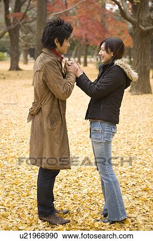 Young couple standing face to face View Large Photo Image Stock Image - Young couple standing face to face. Fotosearch