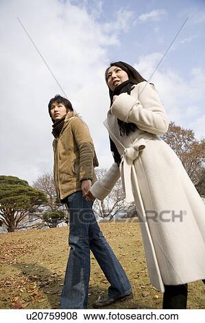 Young couple walking View Large Photo Image Stock Photo - Young couple walking. Fotosearch
