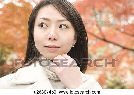 Stock Photo - Young woman looking away. Fotosearch