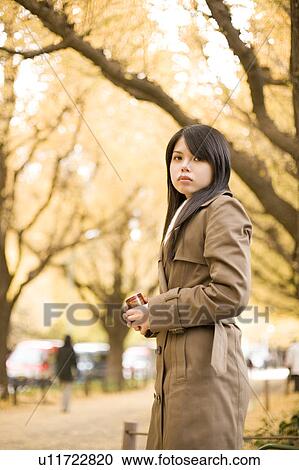 Stock Image - Young woman standing. Fotosearch
