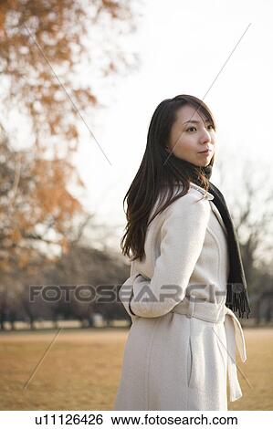 Stock Photograph - Young woman standing. Fotosearch