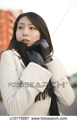 Stock Photo - Young woman wearing scarf. Fotosearch