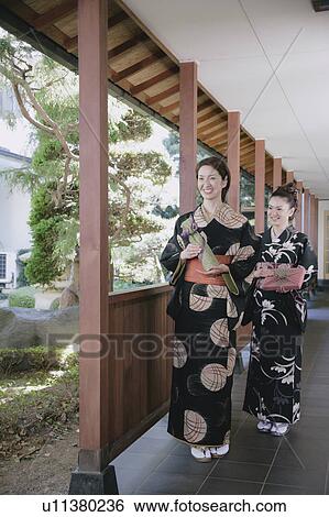 Two young women in kimono holding wrapped gifts View Large Photo Image Stock Photograph - Two young women in kimono holding wrapped gifts. Fotosearch