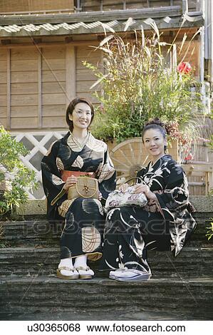 Two young women in kimono sitting on steps View Large Photo Image Stock Photo - Two young women in kimono sitting on steps. Fotosearch