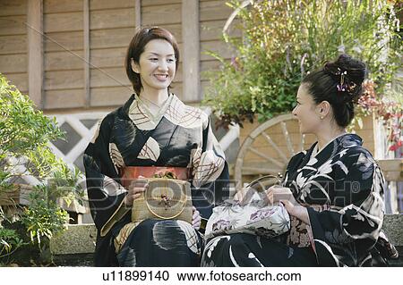 Two young women in kimono talking View Large Photo Image Stock Image - Two young women in kimono talking. Fotosearch