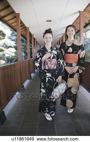 Stock Photo - Two young women in kimono walking. Fotosearch