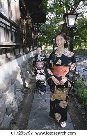 Stock Photo - Two young women in kimono walking. Fotosearch