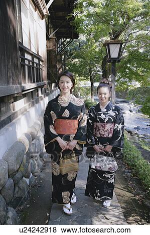 Stock Photo - Two young women in kimono walking. Fotosearch