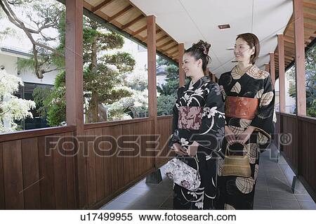 Stock Photography - Two young women in kimono walking. Fotosearch
