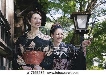 Stock Photography - Two young women in kimono walking. Fotosearch