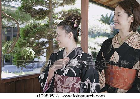 Stock Photo - Two young women wearing kimono. Fotosearch