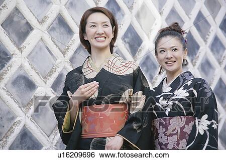 Two young women wearing kimono View Large Photo Image Stock Photograph - Two young women wearing kimono. Fotosearch