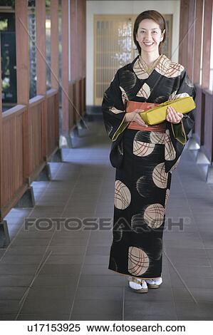 Young woman in kimono holding gift box View Large Photo Image Stock Photography - Young woman in kimono holding gift box. Fotosearch