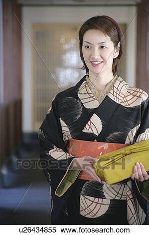 Young woman in kimono holding gift box View Large Photo Image Stock Photography - Young woman in kimono holding gift box. Fotosearch