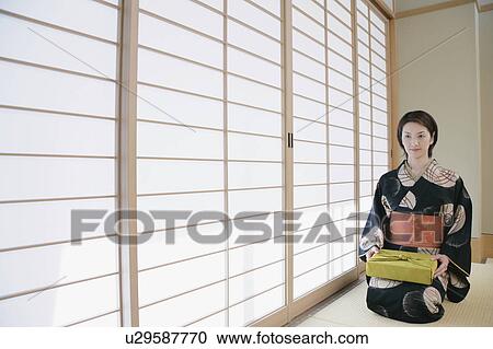 Young woman in kimono sitting on floor View Large Photo Image Stock Image - Young woman in kimono sitting on floor. Fotosearch