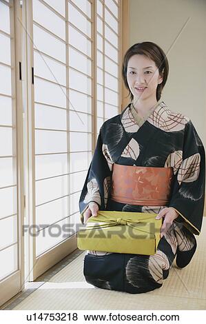 Young woman in kimono sitting on floor View Large Photo Image Stock Photo - Young woman in kimono sitting on floor. Fotosearch