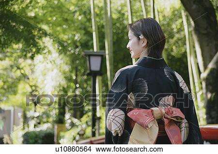 Picture - Young woman wearing kimono, rear view. Fotosearch