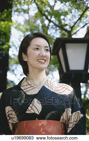 Stock Image - Young woman wearing kimono. Fotosearch