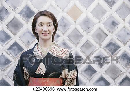 Young woman wearing kimono View Large Photo Image Stock Image - Young woman wearing kimono. Fotosearch