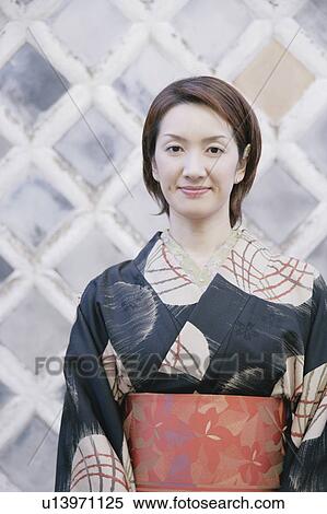 Young woman wearing kimono View Large Photo Image Stock Photography - Young woman wearing kimono. Fotosearch