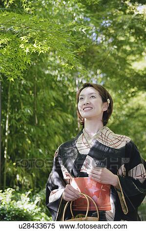 Stock Photography - Young woman wearing kimono. Fotosearch