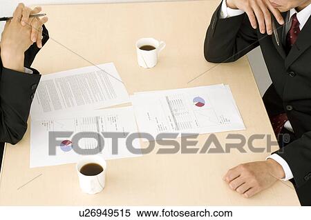 Stock Photography - Business people having meeting. Fotosearch