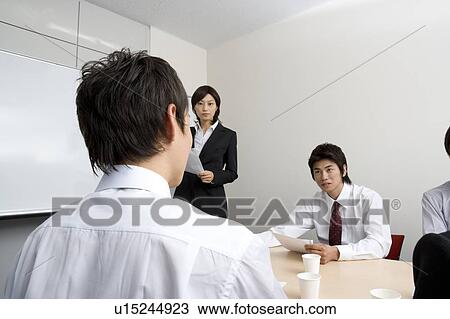 Stock Image - Group of business people having meeting. Fotosearch