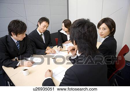 Stock Image - Group of business people having meeting. Fotosearch