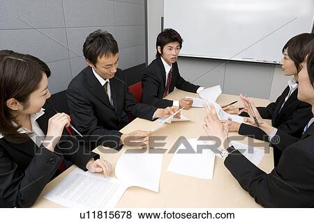 Stock Photo - Group of business people having meeting. Fotosearch