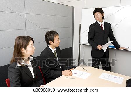 Stock Photo - Group of business people having meeting. Fotosearch