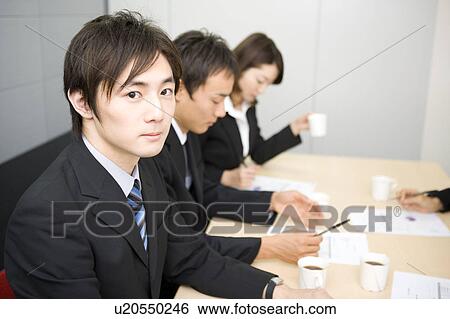 Stock Photograph - Group of business people having meeting. Fotosearch