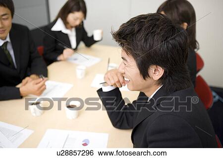Stock Photograph - Group of business people having meeting. Fotosearch