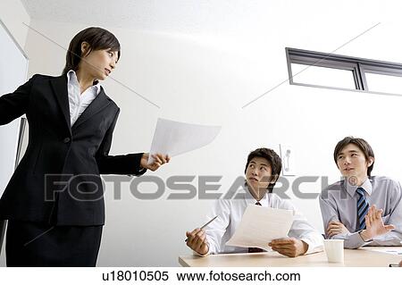 Stock Photography - Group of business people having meeting. Fotosearch