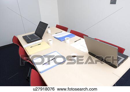 Stock Photograph - Laptops and documents on desk. Fotosearch