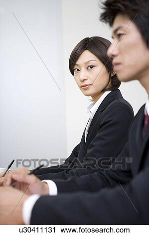Two young business people having meeting View Large Photo Image Stock Image - Two young business people having meeting. Fotosearch