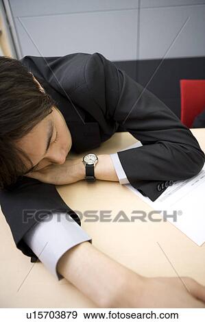Young businessman sleeping during meeting View Large Photo Image Stock Photo - Young businessman sleeping during meeting. Fotosearch