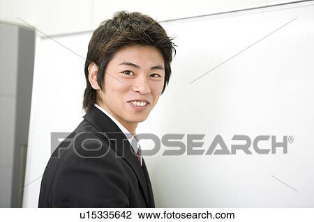 Stock Image - Young businessman smiling. Fotosearch
