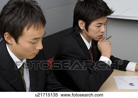 Stock Photography - Young businessmen having meeting. Fotosearch