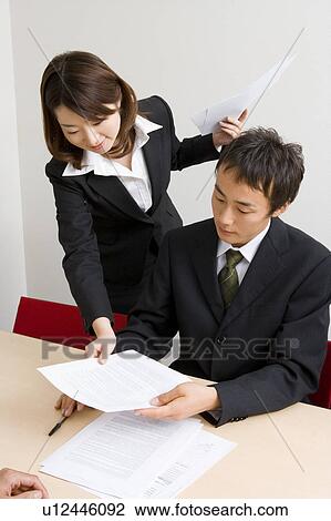 Young businesswoman giving document to colleague View Large Photo Image Stock Image - Young businesswoman giving document to colleague. Fotosearch