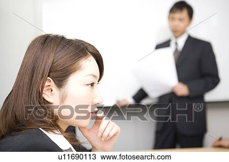 Stock Image - Young businesswoman in meeting. Fotosearch