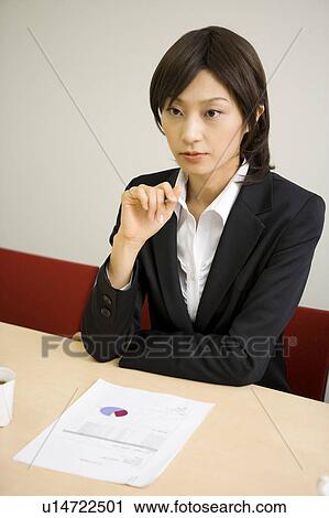 Stock Image - Young businesswoman in meeting. Fotosearch