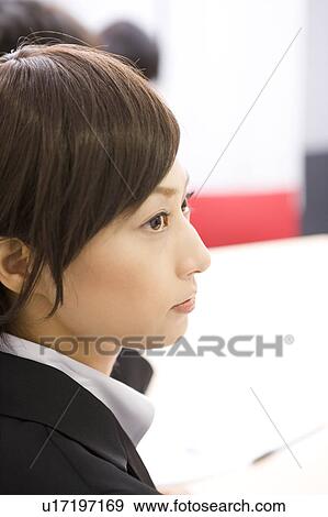 Stock Photo - Young businesswoman in meeting. Fotosearch
