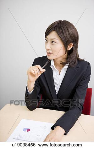 Stock Photograph - Young businesswoman in meeting. Fotosearch
